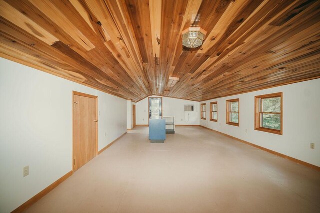 unfurnished room with wood ceiling, vaulted ceiling, and baseboards