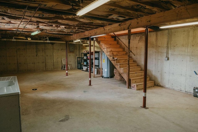 unfinished below grade area with water heater and stairway