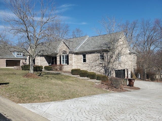 view of front facade featuring brick siding and a front yard