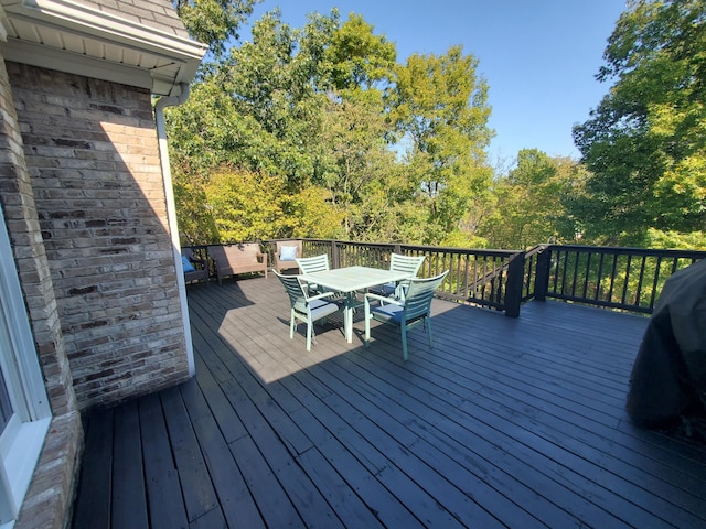 wooden terrace with outdoor dining space