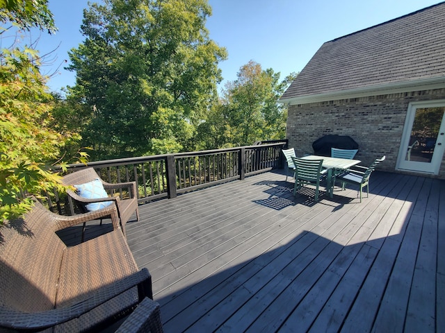 wooden terrace featuring outdoor dining space