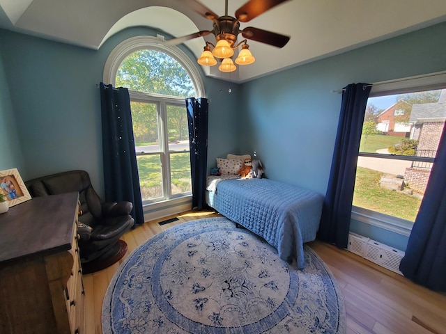 bedroom featuring visible vents, ceiling fan, and light wood-style flooring