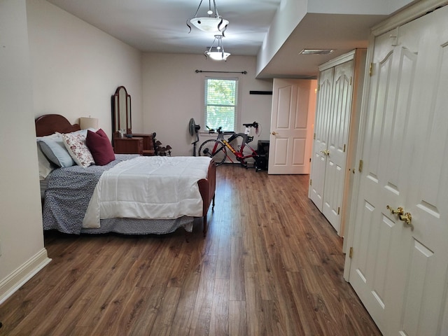 bedroom with dark wood-type flooring