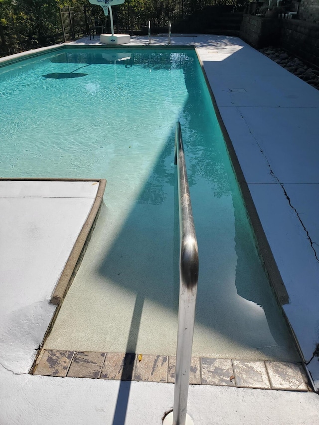 view of pool featuring fence