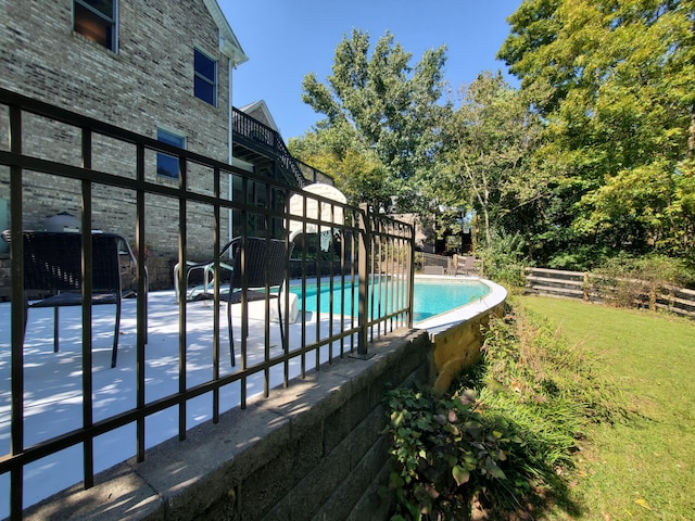 view of swimming pool with a patio area, fence, and a fenced in pool