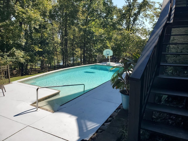 outdoor pool with fence and stairway