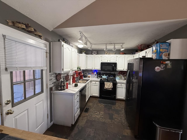 kitchen with a sink, white cabinetry, light countertops, backsplash, and black appliances