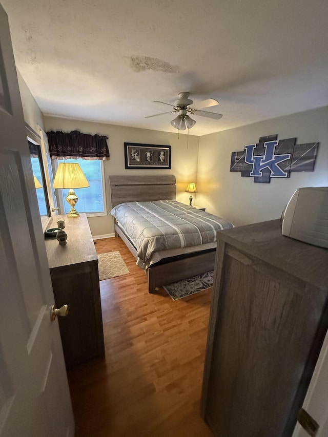 bedroom with wood finished floors and a ceiling fan