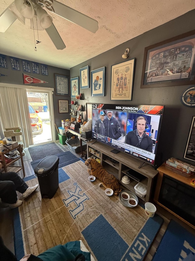 game room featuring a textured ceiling and a ceiling fan