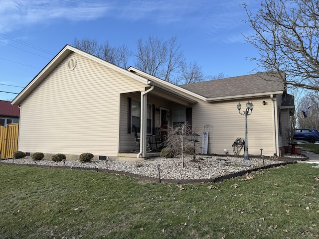 view of side of property with a shingled roof, crawl space, a yard, and fence