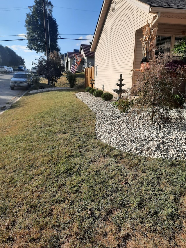 view of property exterior featuring a lawn