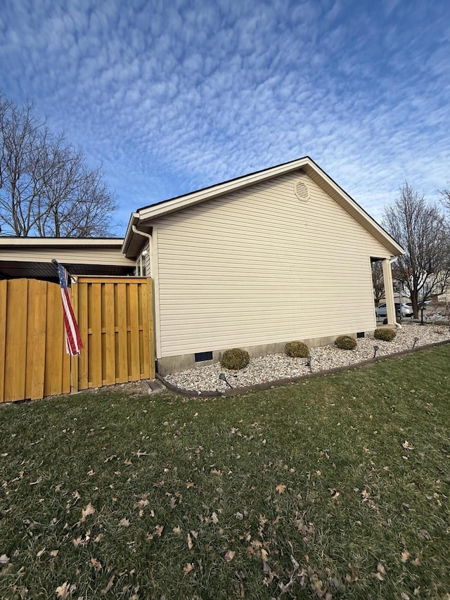 view of property exterior with a yard and crawl space