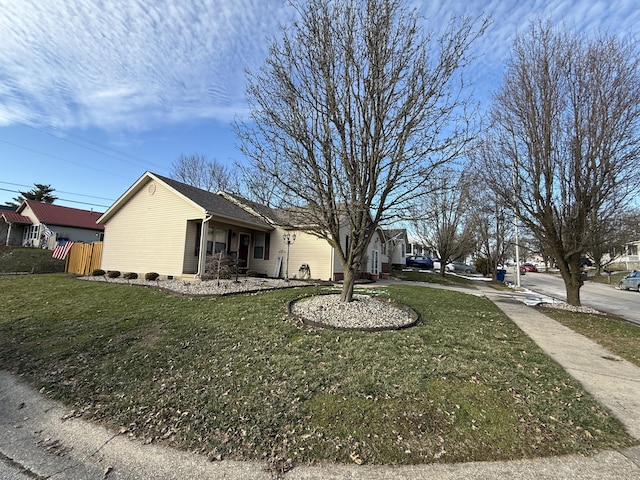 exterior space featuring a front yard and fence