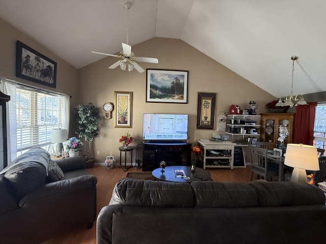 living area with a ceiling fan, lofted ceiling, baseboards, and wood finished floors