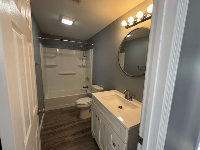 bathroom with vanity, bathing tub / shower combination, wood finished floors, and toilet