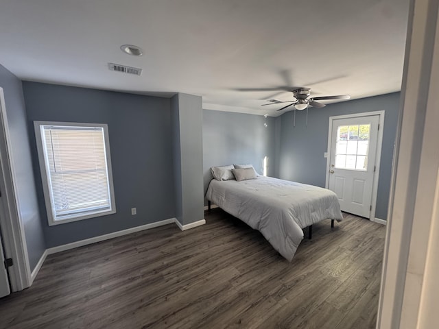 bedroom with a ceiling fan, visible vents, dark wood finished floors, and baseboards