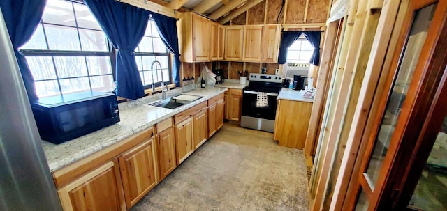 kitchen featuring a sink, light stone counters, and electric stove