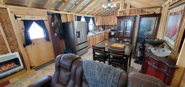 kitchen featuring appliances with stainless steel finishes, heating unit, light countertops, a chandelier, and a sink