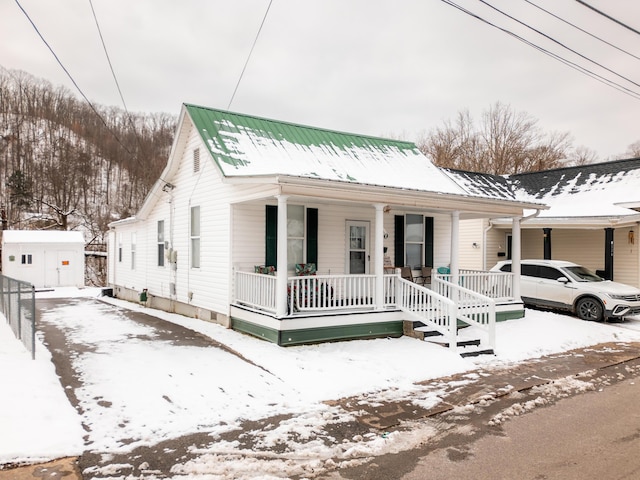 view of front of home featuring covered porch and metal roof