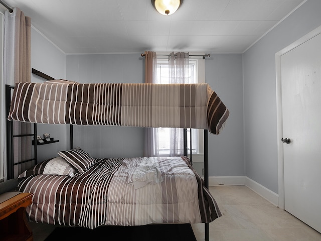 bedroom with crown molding and baseboards