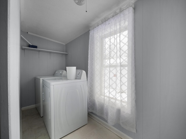 laundry room with laundry area, separate washer and dryer, and light tile patterned flooring