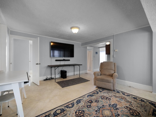 living room with baseboards, ornamental molding, and a textured ceiling