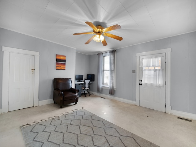 entrance foyer with ceiling fan, visible vents, baseboards, and ornamental molding