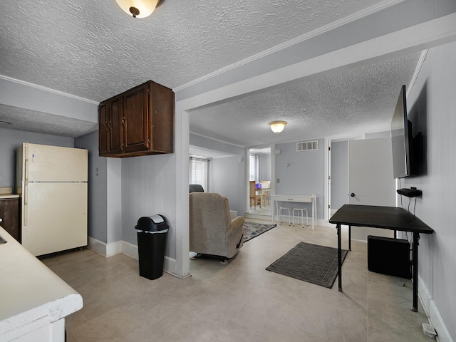 living area with light floors, visible vents, a textured ceiling, and baseboards