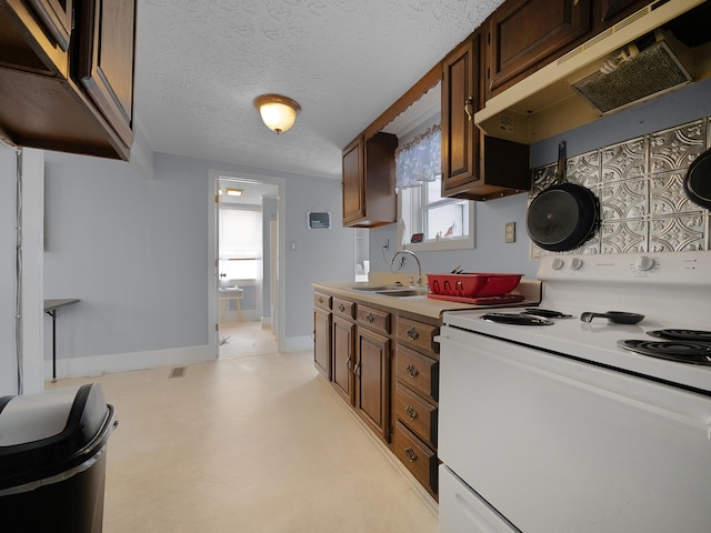 kitchen with white electric range oven, baseboards, light countertops, under cabinet range hood, and a sink