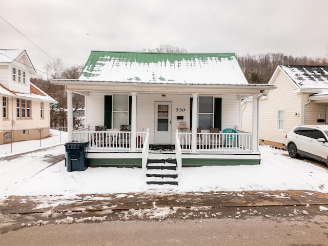 bungalow-style home with metal roof and a porch