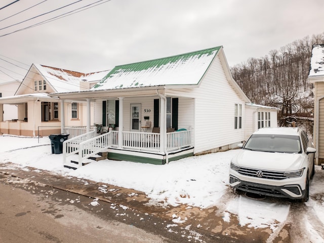 view of front facade with metal roof and a porch