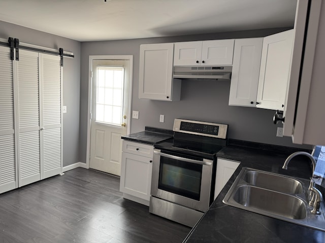 kitchen with white cabinets, dark countertops, stainless steel electric range, under cabinet range hood, and a sink