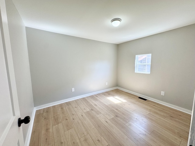 unfurnished room with visible vents, baseboards, and light wood-style floors