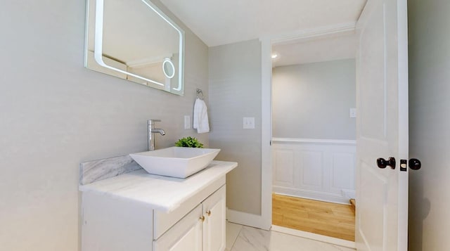 bathroom with marble finish floor and vanity