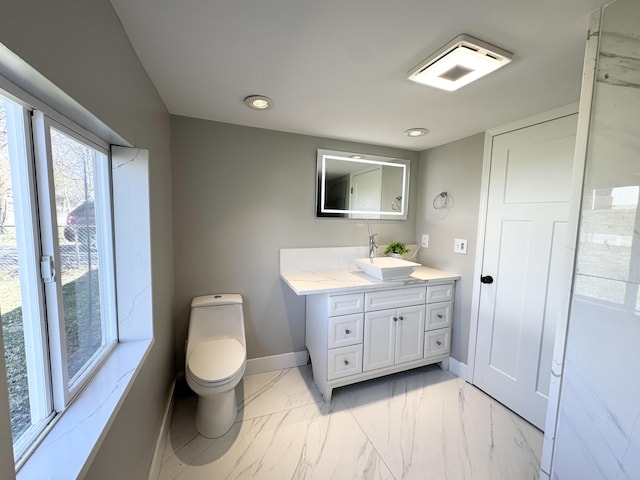 bathroom with baseboards, toilet, recessed lighting, marble finish floor, and vanity