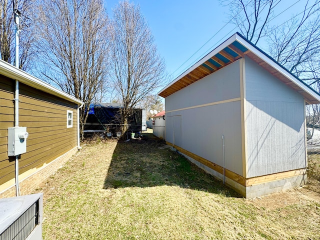 view of home's exterior featuring an outbuilding and a lawn