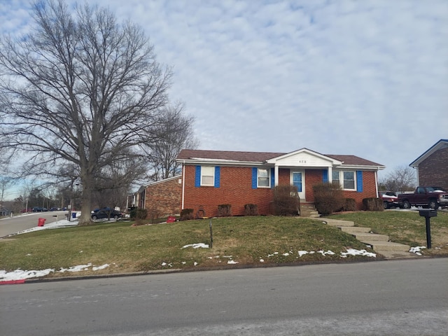 view of front of property featuring brick siding and a front yard