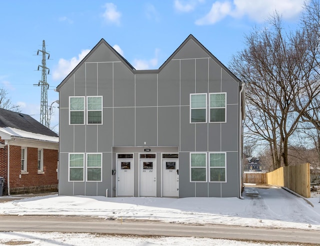 modern home with board and batten siding and fence