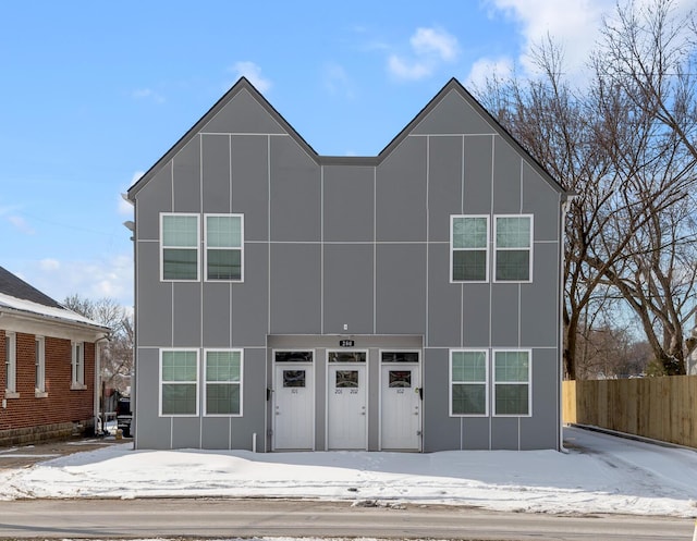 view of front of house with board and batten siding and fence