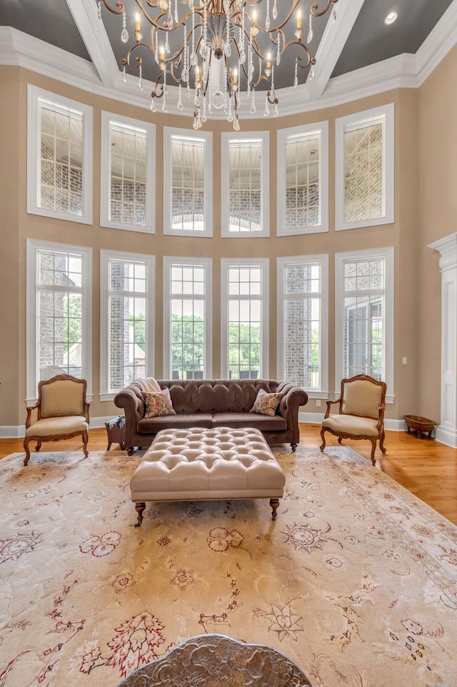 living room with plenty of natural light, wood finished floors, and crown molding