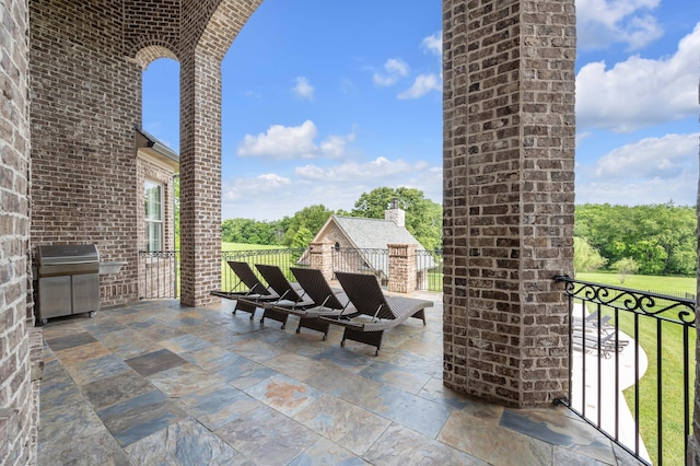 view of patio with a balcony and grilling area