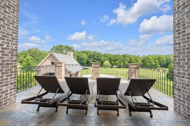 view of patio featuring a balcony