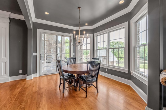 dining area with light wood-style flooring, recessed lighting, crown molding, baseboards, and an inviting chandelier