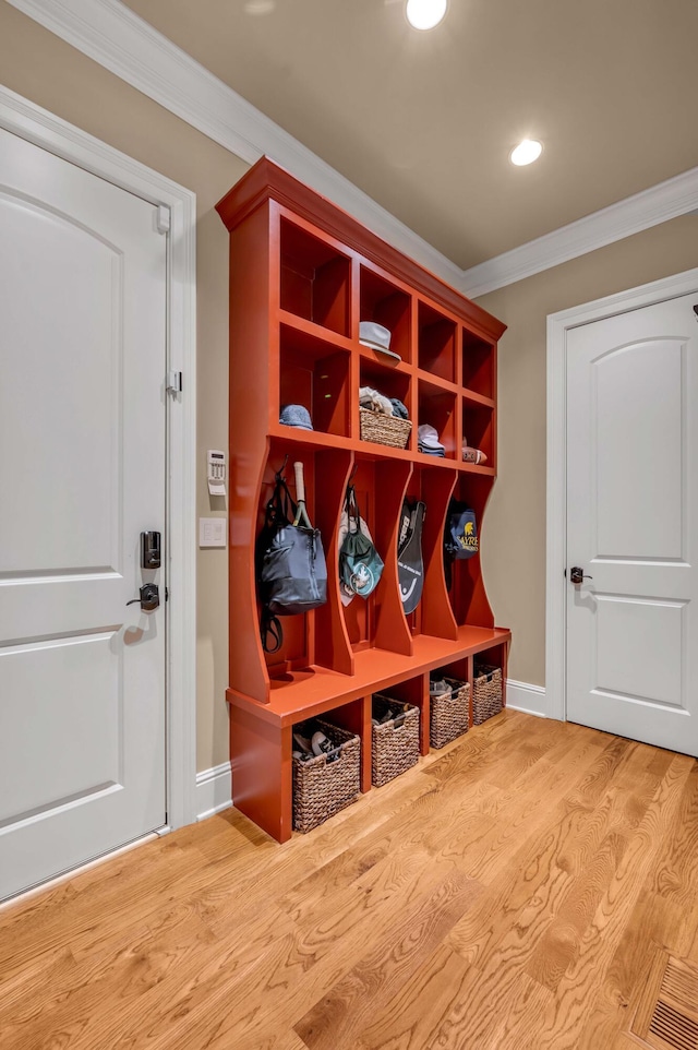 mudroom with ornamental molding, recessed lighting, wood finished floors, and baseboards