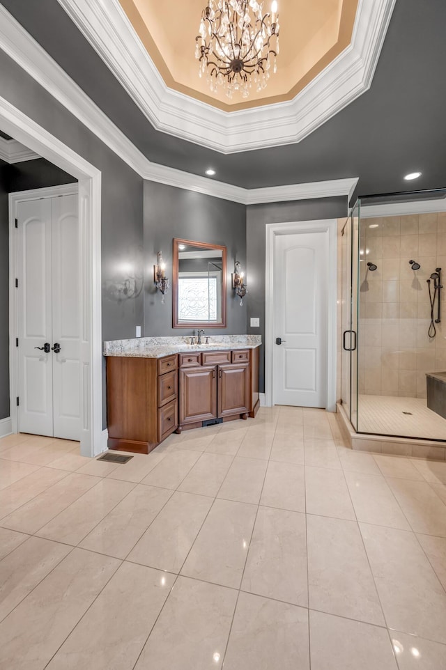 full bath featuring ornamental molding, a shower stall, vanity, a chandelier, and tile patterned floors