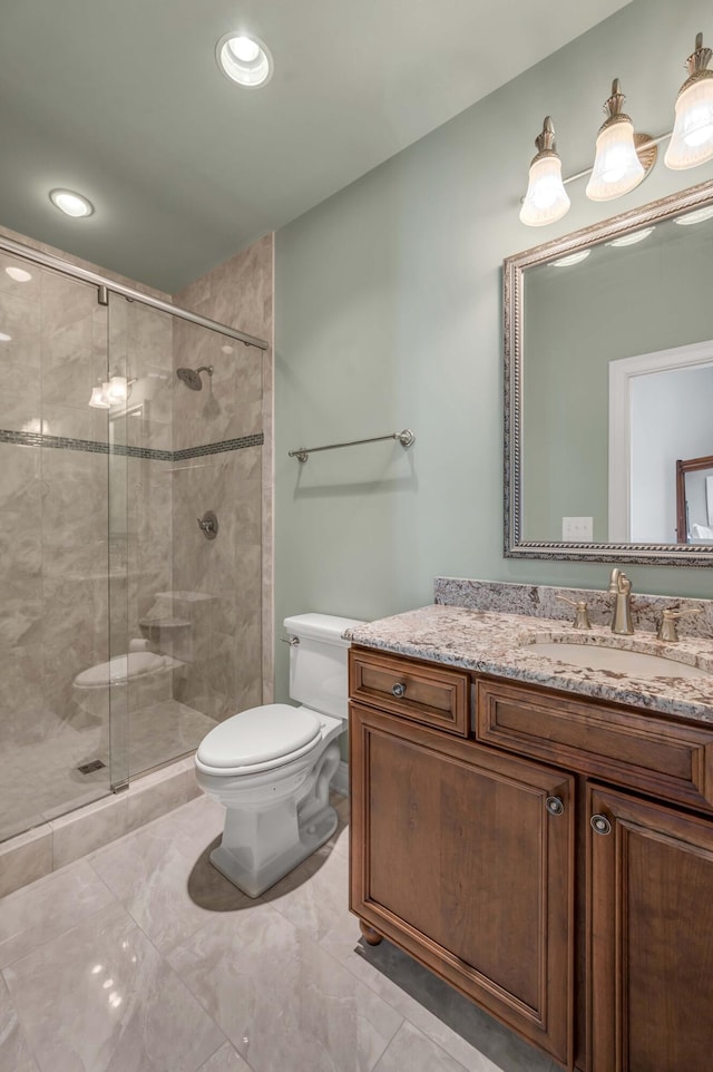 full bathroom featuring toilet, a stall shower, recessed lighting, and vanity