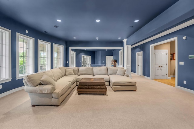 living room featuring light carpet, baseboards, and recessed lighting