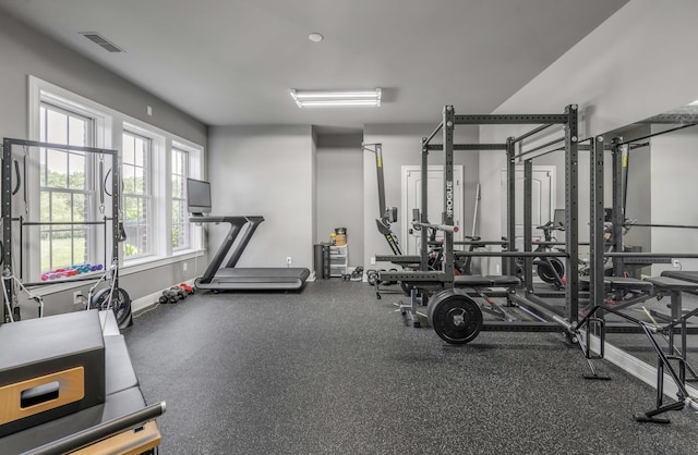 gym featuring baseboards and visible vents