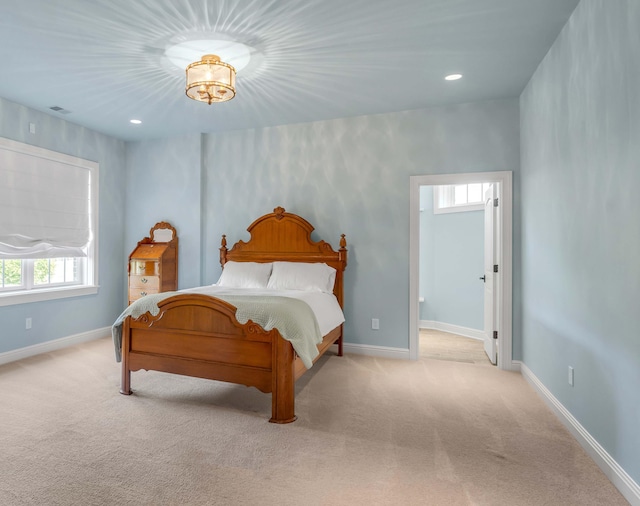 bedroom featuring light carpet, recessed lighting, and baseboards