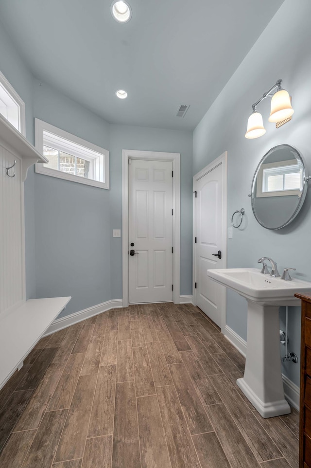 mudroom with wood tiled floor, visible vents, baseboards, and recessed lighting